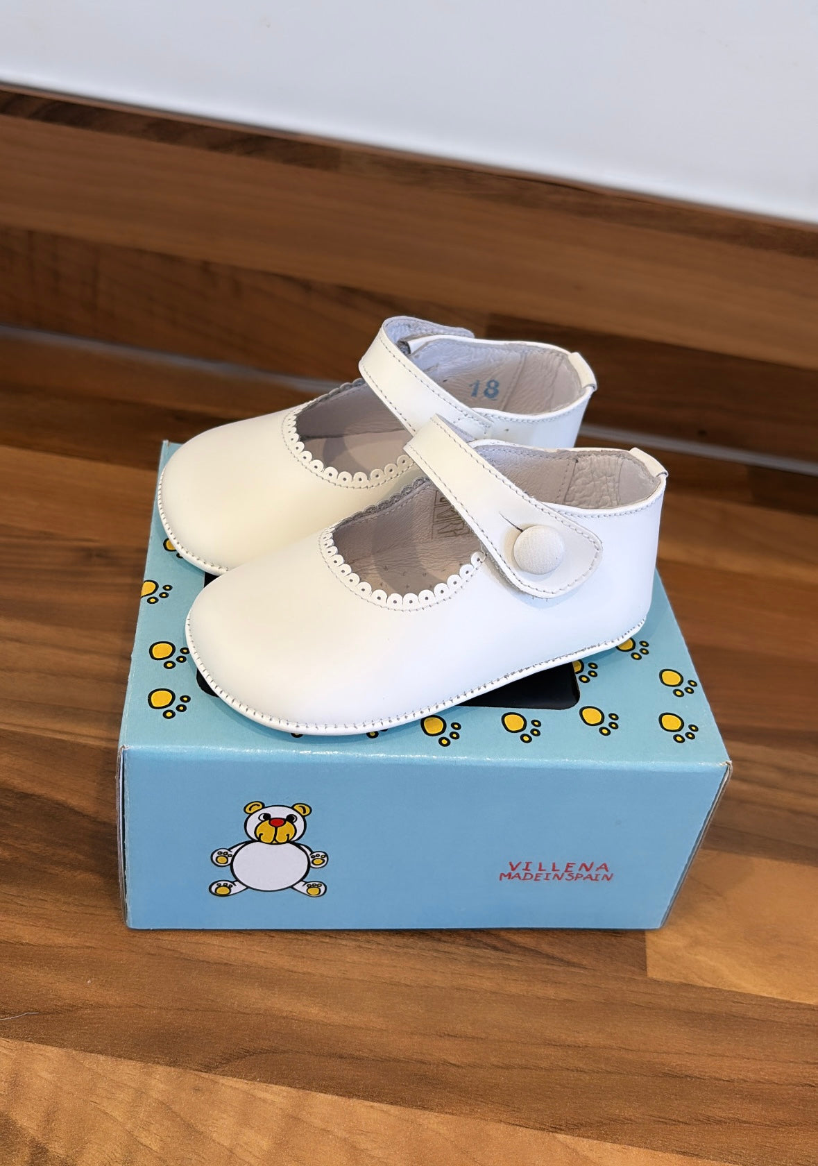 White leather button shoes